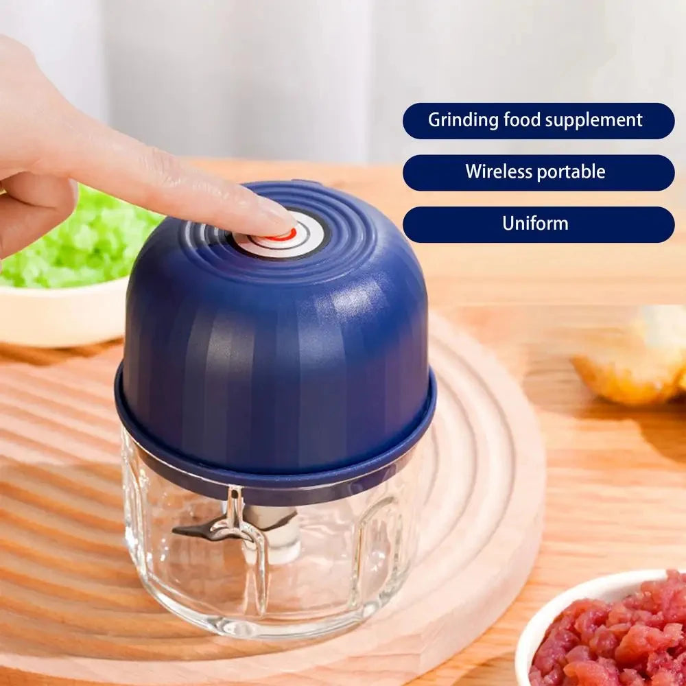 A hand is operating a blue electric grinder mixer jar containing food, demonstrating its grinding function.