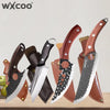 A set of handmade forged butcher and chef knives with wooden handles displayed on a light surface.