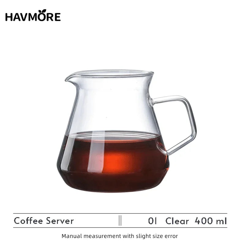 A clear glass coffee server with a handle, used for manual measurement of coffee.