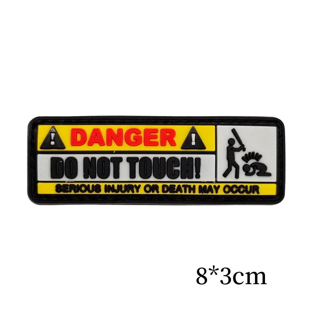 Black and yellow warning patch with text saying Danger Do Not Touch Serious Injury or Death May Occur