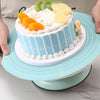 A light blue silicone cake turntable baking mat is shown with a decorated cake and fruit on a white platter.