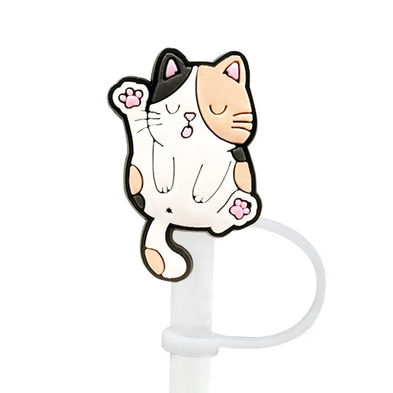 A cute white and black cat silicone straw cover attached to a white cup straw.