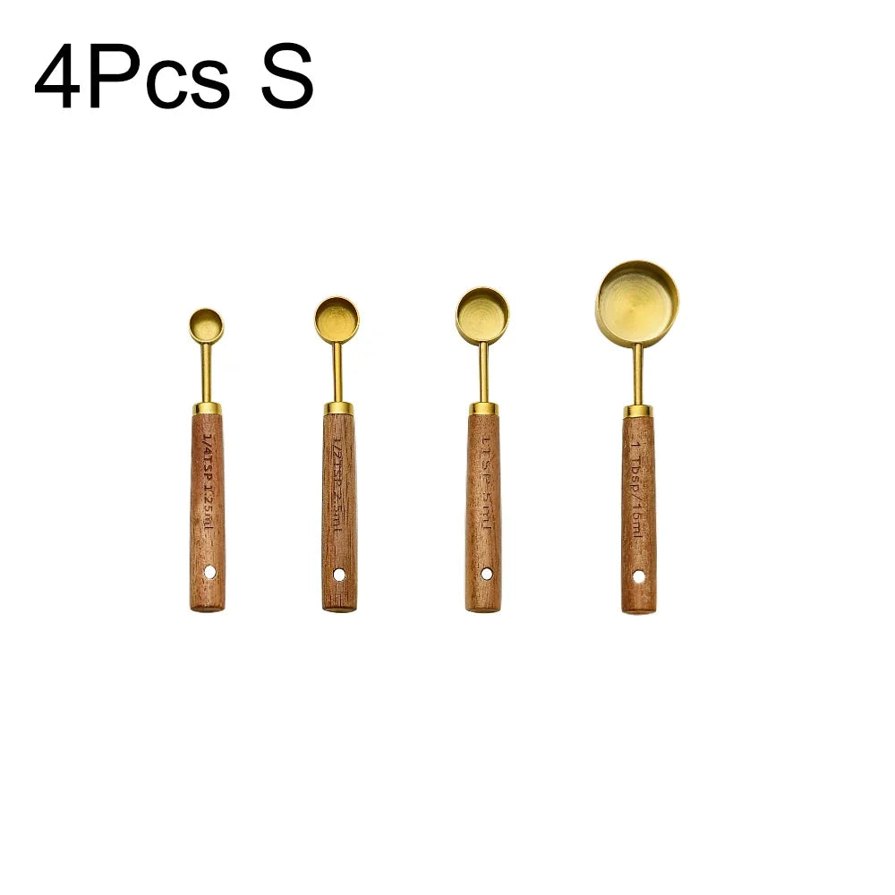 Four stainless steel spoons with wooden handles for measuring
