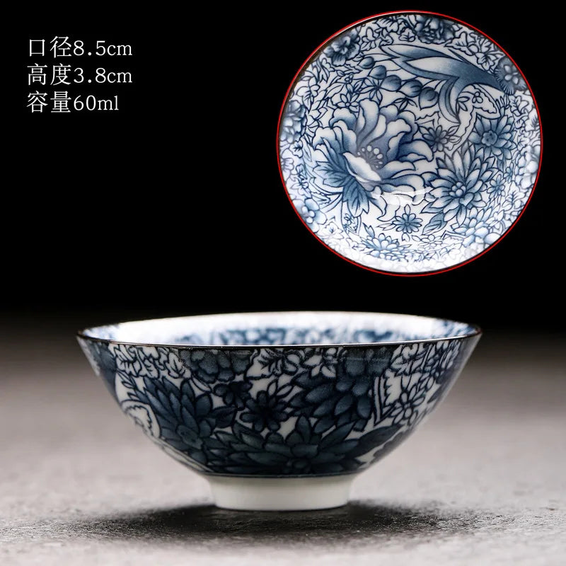 A handmade blue and white porcelain bowl with floral patterns is shown against a dark background.