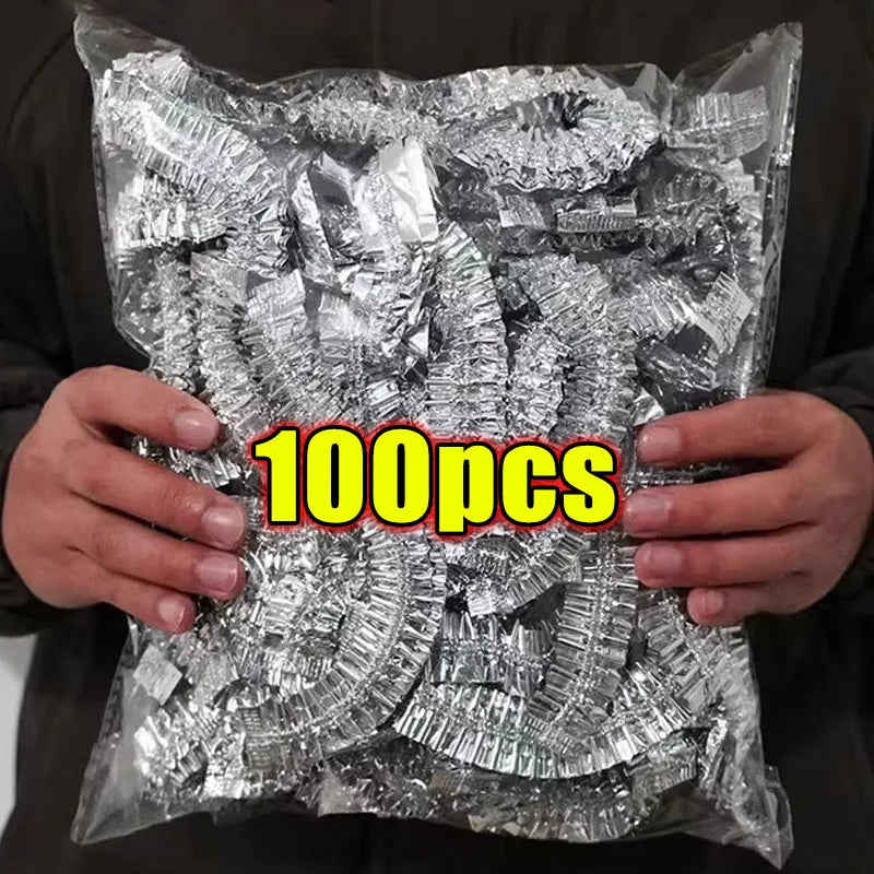 A hand holds a clear plastic bag filled with 100 pieces of silver aluminum foil food covers.