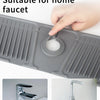 A hand points to a silicone sink splash guard mat designed for a home faucet.