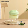 A small light green reusable and leakproof portable food container sitting on a woven mat.