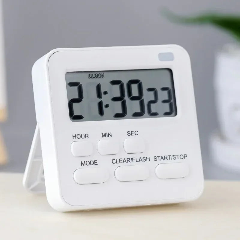 A white digital kitchen timer displaying 21:39:23 with function buttons.