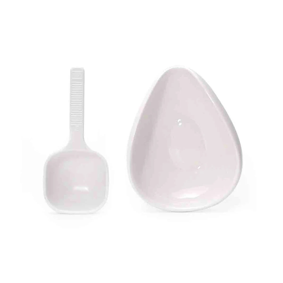 A white ceramic coffee dosing and spray kit showing a spoon and a small dish.
