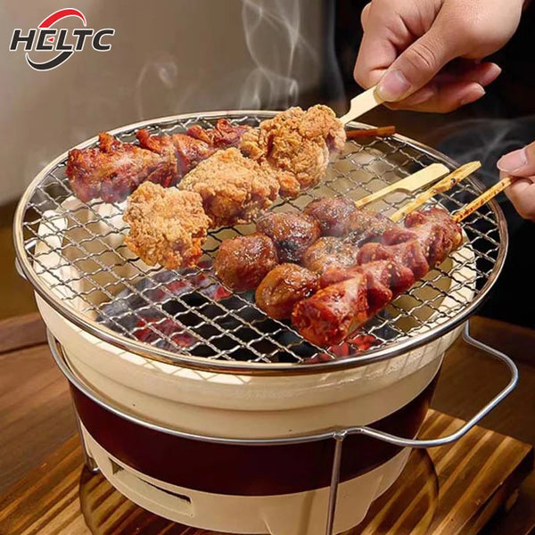 A hand is grilling seasoned meat skewers on a round stainless steel BBQ grate net.