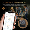 A hand holds a smartphone displaying a cooking temperature reading, next to an Inkbird meat thermometer.