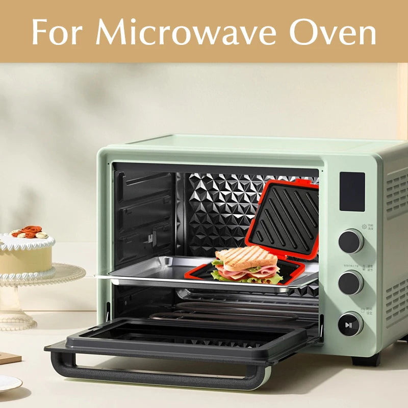 A food grade silicone microwave sandwich maker is shown open inside a light green microwave oven, ready for use.