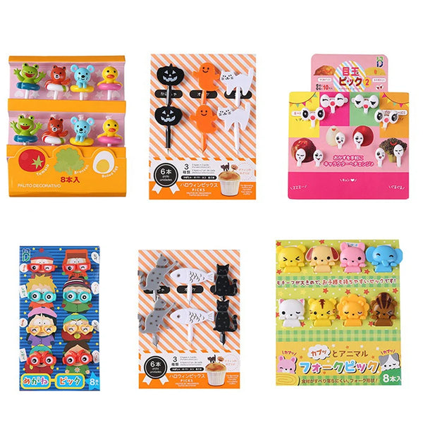 Ein Set süßer Früchte- und Dessert-Picks für Kinder mit verschiedenen bunten Lebensmittelförmchen.
