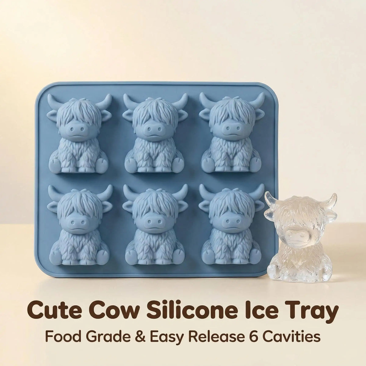 A blue silicone ice tray with six cavities is shown next to a small, clear cow-shaped silicone mold.