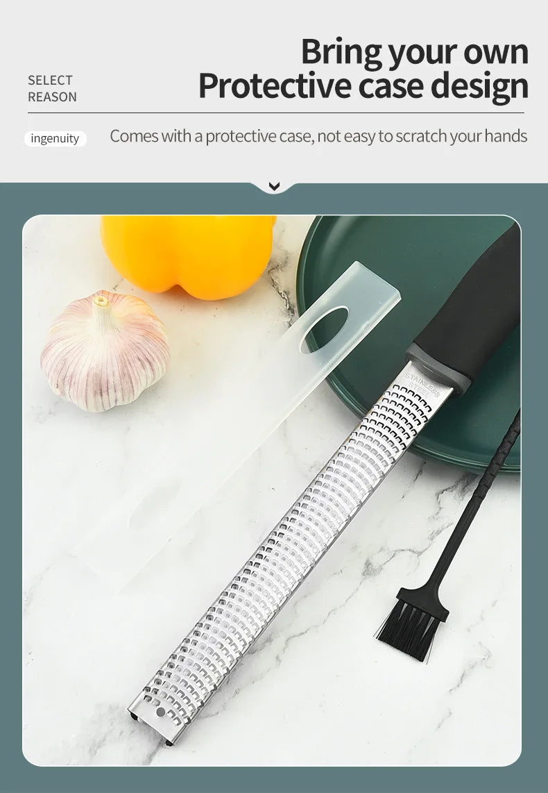 A stainless steel citrus grater and zester with a clear handle is shown next to a clove of garlic on a white surface.
