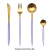 A set of four purple and gold stainless steel cutlery including a fork, spoon, and two knives.