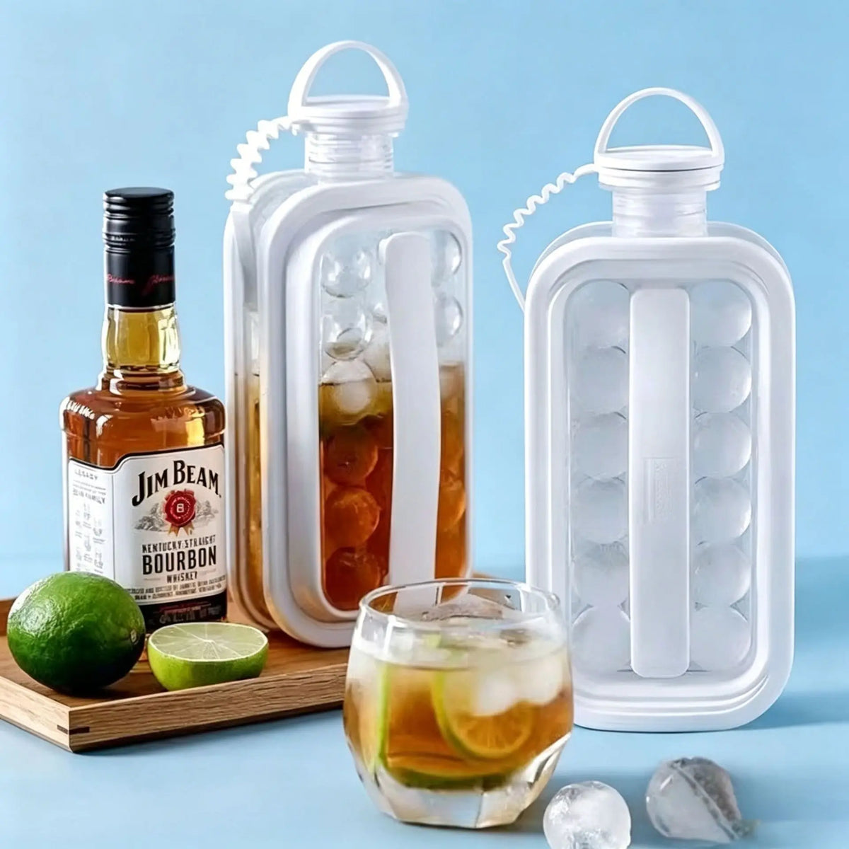 A clear plastic ice cube maker in a bottle design sits next to a bottle of Jim Beam bourbon and a lime.