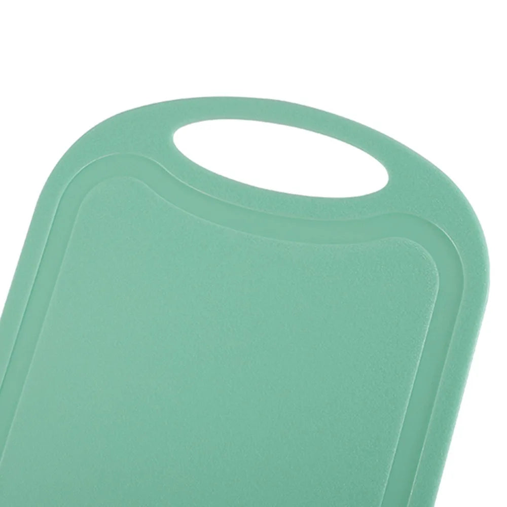 A light mint green non-slip plastic cutting board with a hanging handle.