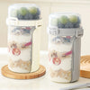 Two clear reusable containers filled with overnight oats or snacks, featuring a light gray and white design.