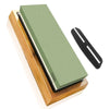 A professional multi-grits knife sharpening stone set with a green stone and black sharpening rod resting on a wooden base.