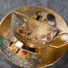 A gold-toned luxury bone china tea set featuring ceramic cups and saucers with intricate patterns.