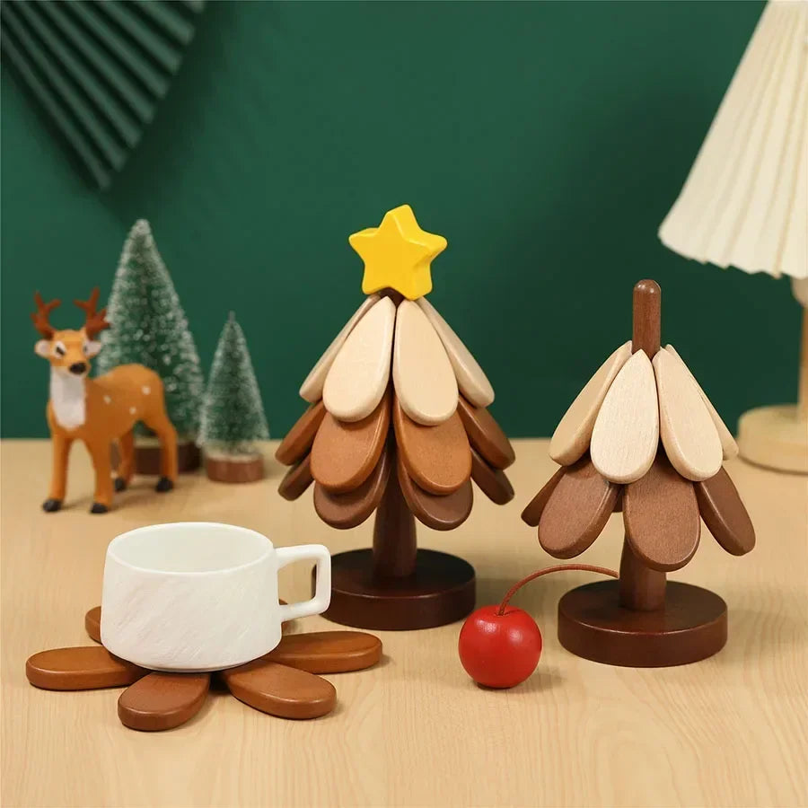 A natural wood foldable trivet shaped like a Christmas tree with a yellow star and an apple, set against a dark green backgro