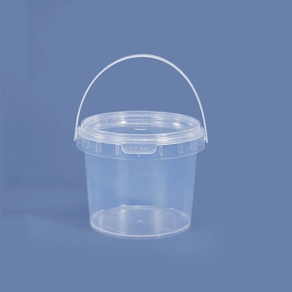 A clear plastic storage bucket with a handle is shown against a solid blue-gray background.