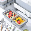 A silicone food storage tray filled with fruit and yogurt is shown next to a white electric appliance.