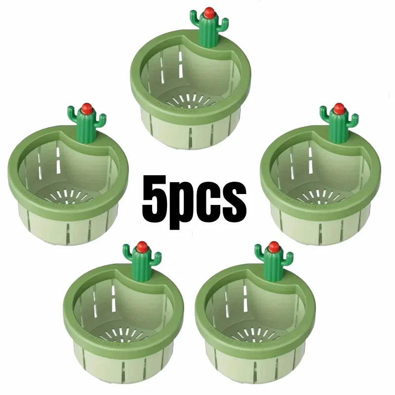 Five green plastic automatic cactus sink drain strainers with red tops.