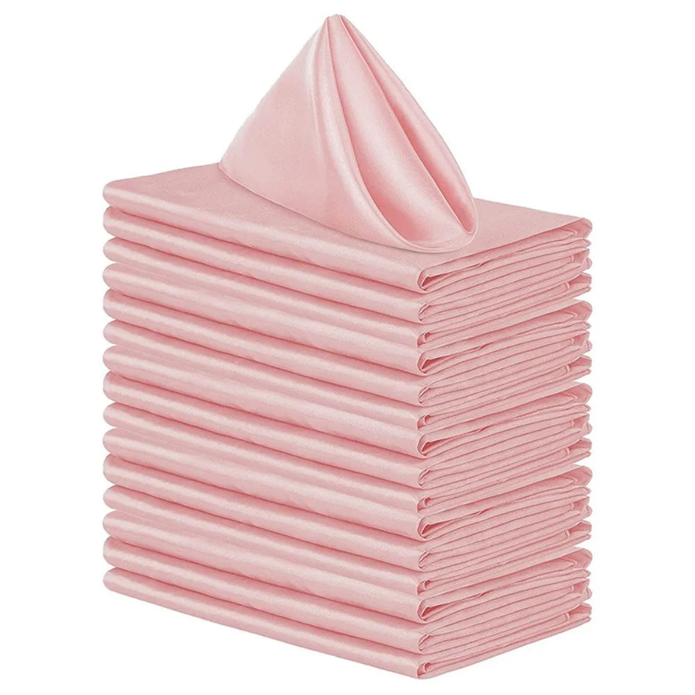 A stack of ten pink satin dinner napkins folded neatly.
