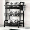 A black 3-tier vertical kitchen utensil dish rack holding various circular dishes and utensils.