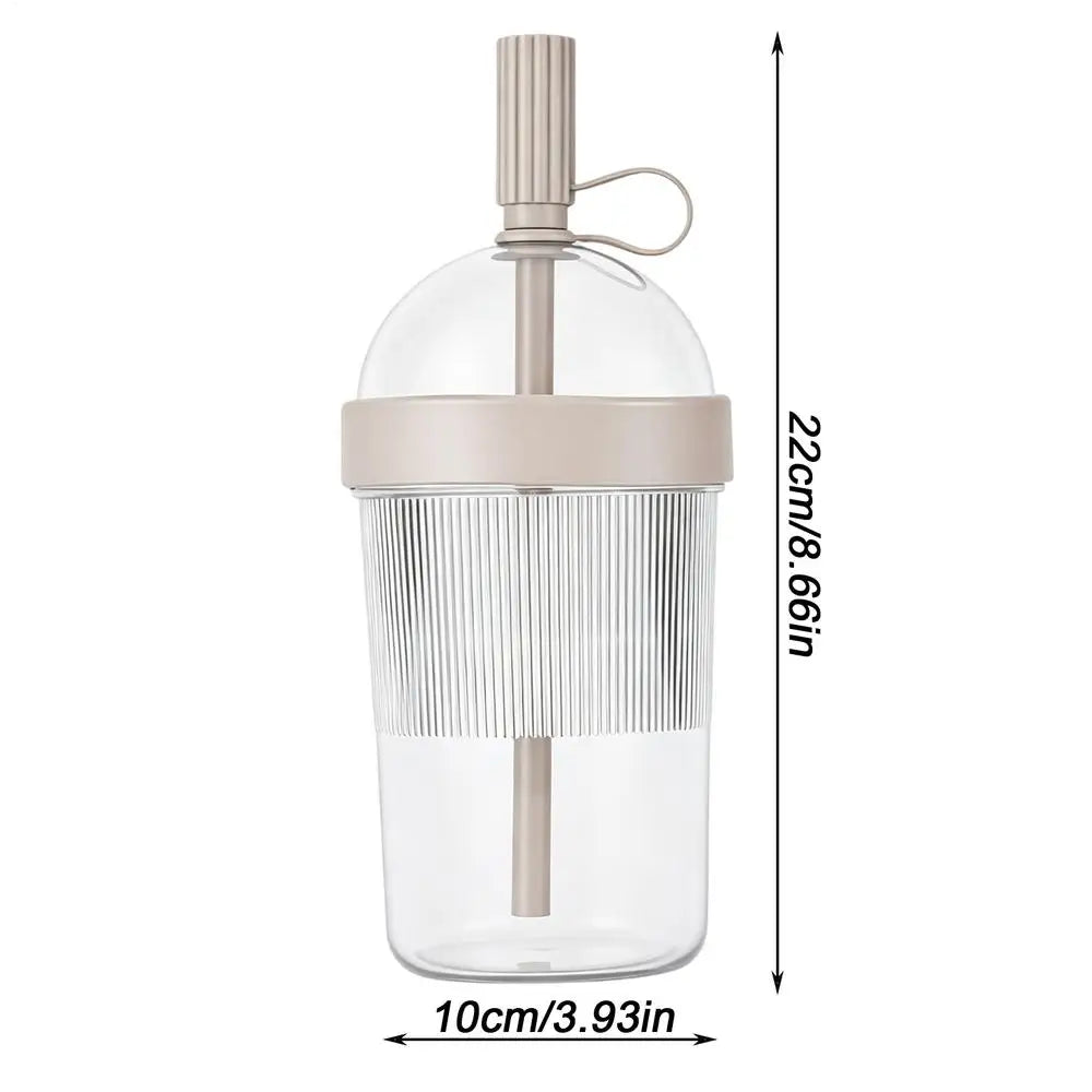 Clear reusable tumbler coffee cup with a straw lid and a light beige silicone base