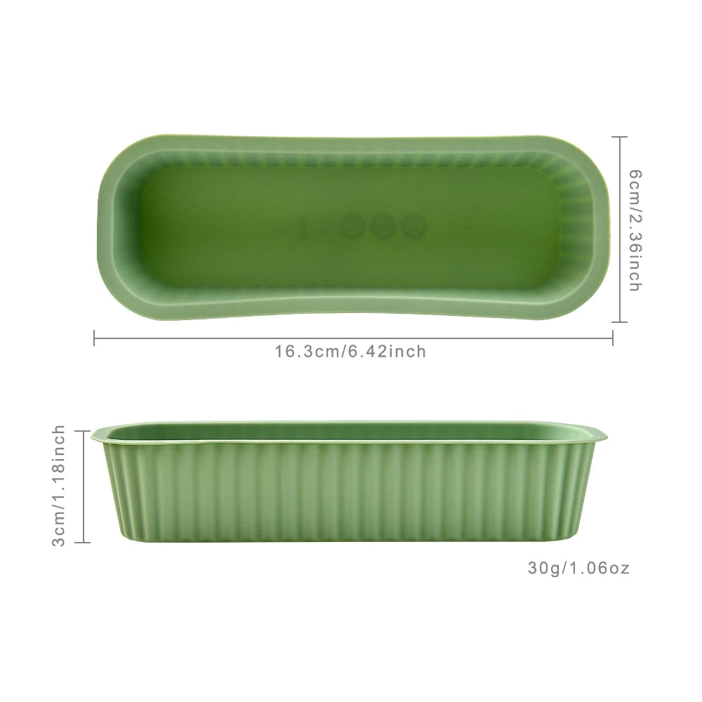 A light green silicone mini loaf baking pan with dimensions 6cm x 2.36 inches and a weight of 30g.
