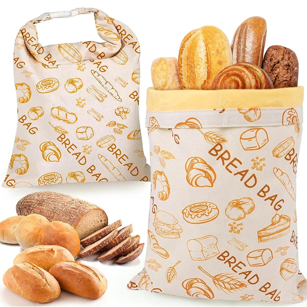 A beige reusable beeswax bread bag filled with various baked goods like rolls and bread.