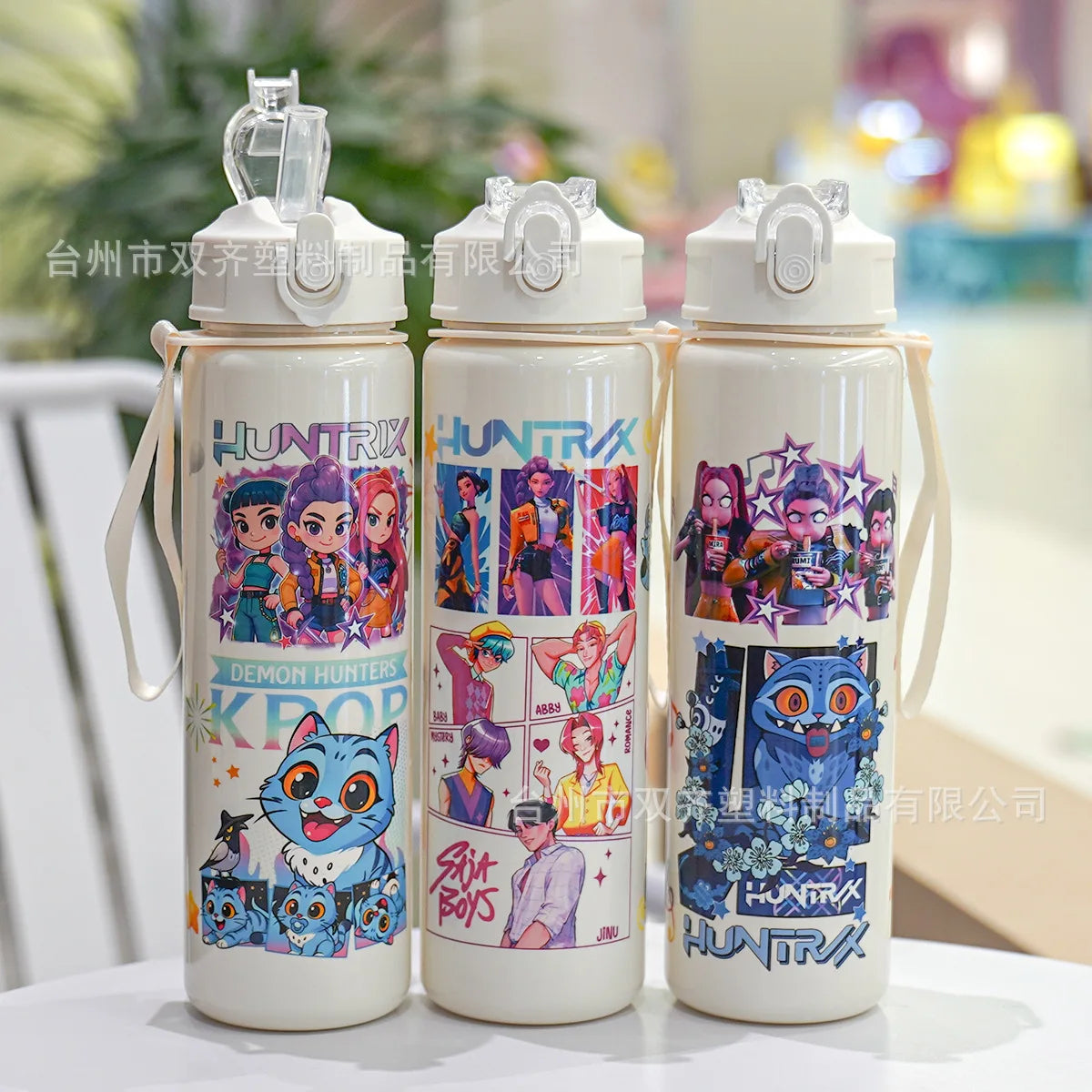Three white insulated water cups featuring different cartoon prints of demon hunters
