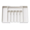 A white adjustable plastic flatware organizer tray with multiple compartments.