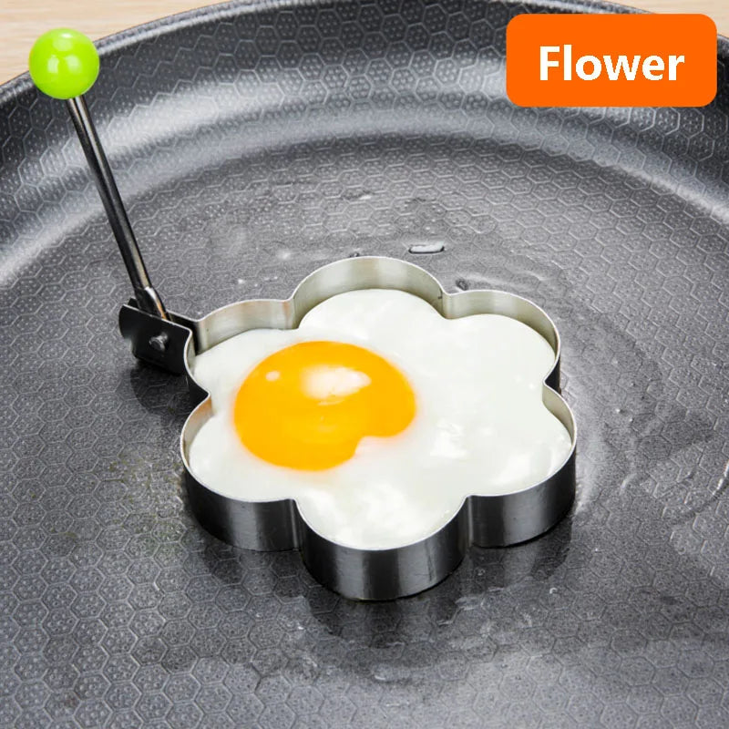 Stainless steel flower-shaped mold for cooking fried eggs or omelettes on a flat pan.