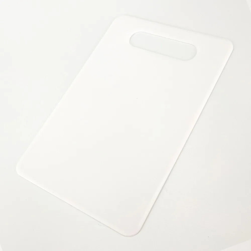 A white plastic cutting board with a handle, shown against a white background.