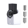 A white electric vegetable slicer with a black cutting disc and multiple grating attachments.