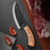 A handmade forged kitchen knife set featuring a large blade with a wooden handle and a piece of raw meat.