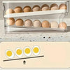 A clear plastic storage rack holds several brown eggs, demonstrating an automatic rolling egg storage system.
