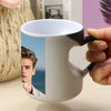 A white coffee mug with a heart handle features a photo of a young man.