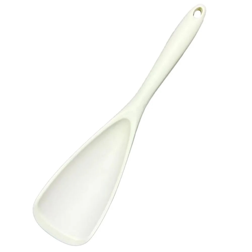 A white heat resistant silicone stirring spoon with a handle.
