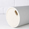 A roll of white silicone knife block organizer with ribbed texture shown on a white surface.