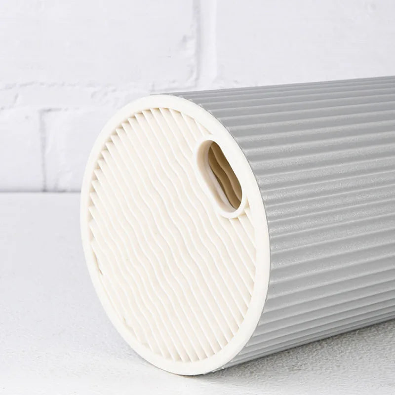 A roll of white silicone knife block organizer with ribbed texture shown on a white surface.