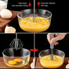 Stainless steel semi-automatic egg beater mixing liquid egg yolks in a glass bowl.