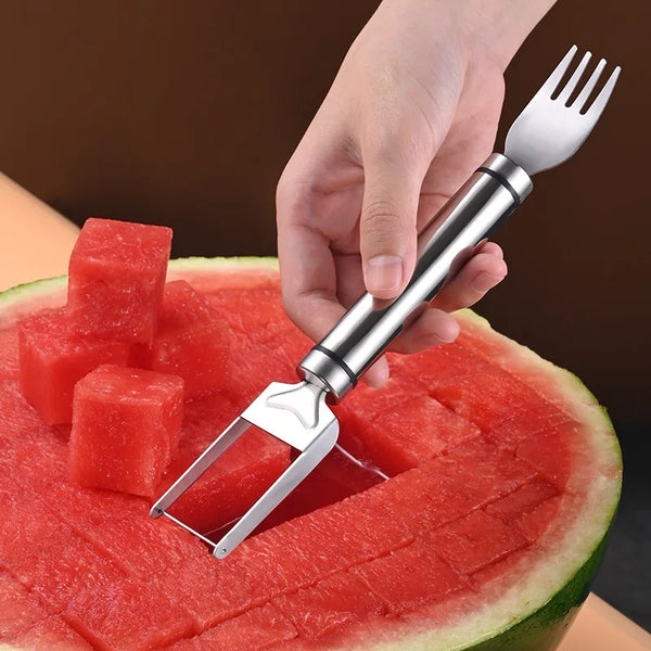 A hand holds a stainless steel watermelon cutting and slicing tool, demonstrating its use on a slice of watermelon.