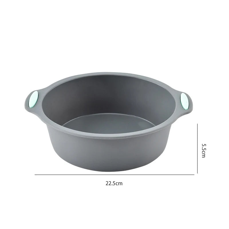 A gray silicone baking pan or mold with small handles, shown from above.