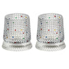 A pair of textured crystal rotating whiskey glasses with colorful gemstone accents.