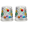 A pair of textured, faceted rotating whiskey glasses filled with colorful glass beads and stones.